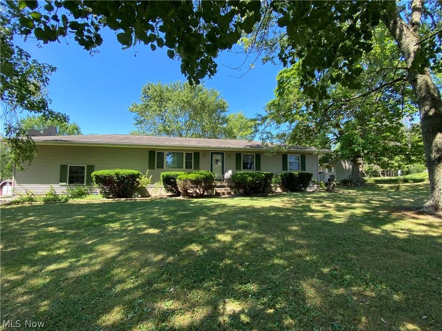 Dreaming of living in the quiet & peacefulness of the country but still want the convenience of quick & easy access to major highways? LOOK NO FURTHER!! This ONE is for YOU!! This 3 bedroom, 1 bath ranch surrounded with wonderful mature shade trees is located in the beautiful area of Seville. This lovely ranch sits on 4 parcels totaling 5.48 acres and it is located less than 5 minutes from I-76/I-71!! Not only will you enjoy the beautiful country life and the quick highway access, the 1.51 acre parcel next to the home is a buildable lot making this a great investment with endless possibilities!! As you enter the home you'll notice the nicely sized living room that leads to the kitchen and newer dining area that has lots of windows allowing an abundance of natural sunlight and overlooks your beautiful back yard!  Off of the dining room is access to the deck & gravel patio area facing the adorable storage shed with its own little front porch! The home has a 2 car garage and there is also another outbuilding making for lots of outside storage.  Three nicely sized bedrooms and a full bath round off the first floor.  The basement is partially finished and includes a very large family room and another bonus room! Call and schedule your private showing today!!