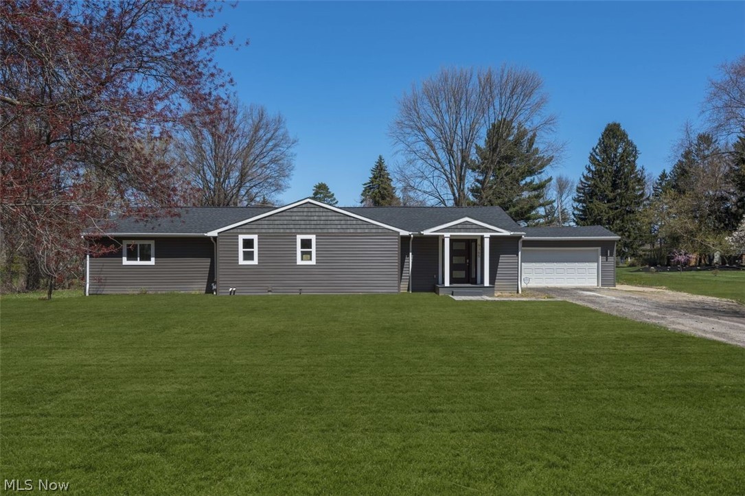 Welcome to this fully renovated 2,226 SF modern Mentor ranch home. The slate grey exterior is sleek with a clean roof line, white accents, and metal lighting. Enter directly into the airy & relaxing open floor plan with vaulted ceilings, skylights, recessed lighting, large windows, and stunning blonde hardwood floors. The kitchen is clearly the heart of this home and features unobstructed flow into the main living space, white tile backsplash, slate grey stainless steel appliances, customized cabinetry, and accent grey large center island. The eat-in dining area & living room grant direct access to the back deck. The master suite is spacious + full of natural light and boasts walk in closet & revamped spa-like bathroom with double marble vanity, tile backsplash, extra wide shower, and modern sconces. All 4 bedrooms have brand new plush carpet and ample closet space. The unfinished basement with two crawl spaces is an opportunity to build out additional entertainment square footage!