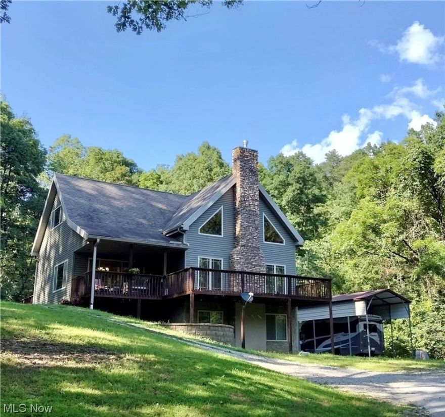 Rare find with this beautiful Chalet style Cape Cod on 17 mostly wooded acres!! This home features 11' first floor ceilings and a 22' vaulted pine ceiling and vented gas log fireplace in the living room. Enjoy feeling like you're on vacation every day when you wake up and have your morning coffee on one of the 5 decks. This wonderful home has convenient main floor living with kitchen, owner's suite (with walk-in shower), den and laundry on same level. The home features 4 bedrooms and 3.5 baths. The 4th bedroom can be used as an efficiency apartment/suite with its own entrance from the deck. Kitchen has a semi-open concept to living, with attached dining, pretty custom maple cabinetry, hardwood floors and SS appliances. Open loft area on 2nd floor could be another living area or office. Finished walk-out basement w/ family and bonus room, half bath. 2 Car garage on main level, 1 below grade used as workshop and 31X14 RV carport for your large truck, RV, boat or use it as a covered picni