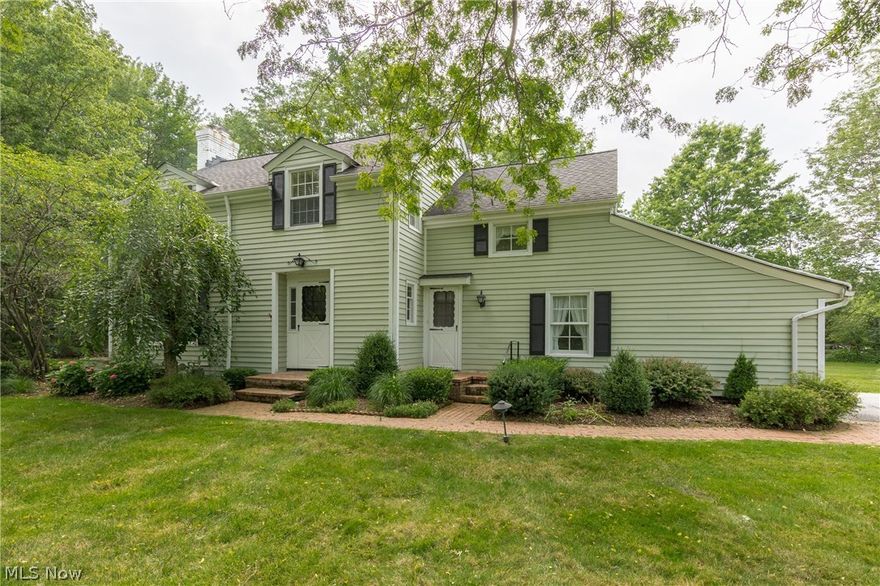 Welcome home to this traditional, New England style colonial tucked away on a private street in Moreland Hills! Formal living room features beautiful hardwood floors, built in shelving, and wood burning fireplace with decorative mantle. Wood paneled family room/den offers a wet bar and overlooks the treed lot. Formal dining room with decorative molding and french doors that open to the deck. Oversized and open country kitchen/family room featuring newer cabinets, hardwood floors, and center island. Convenient first floor laundry.  Second floor master has double closets and additional closet systems. Three bedrooms and and two full baths complete the upper level.  An abundance of closet space including a large cedar closet!  Beautifully landscaped park-like setting! Many newer Pella windows. In-line gas generator, & roof cables! New hot water tank 2017 plus much more! Tremendous character-filled home! Call to schedule your private showing today! Welcome Home!