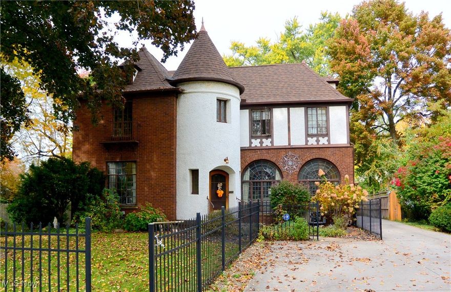 One of a kind! This stunning Tudor style colonial is loaded with charm and amazing architectural details. Enter to the foyer from the beautiful arched wood front door. Foyer has detailed tile floor and huge walk-in coat closet with shelving. Living room features fireplace with wood burner insert and 2 sets of French doors-one leading to the den and the other leading out to a covered patio with arched openings on each side, beautiful brickwork and beadboard wood ceiling. Living room and den have amazing leaded glass sunburst windows over double casement windows. Living room, formal dining room and den have thick mahogany crown molding and refinished mahogany wood floors. Spacious family room has wood burning fireplace and newer plush carpeting. Off the family room is a 4 season sunroom with wood floors and beamed wood ceiling that is a great entertaining space with a large 22x22 concrete patio just outside. Eat-in kitchen has been nicely updated to include Corian countertops, ceramic tile floors, tile backsplash, large pantry and stainless appliances that will stay. The light & bright master suite offers a fully remodeled bath, double closets as well as a cedar closet.  3 other good sized bedrooms, a laundry hook-up and a full bath round out the second floor. Recent updates include newer roof on the house, new boiler and new roof on the garage. Beautiful treed yard includes an extra lot and privacy fenced backyard. This home has it all and is in close proximity, schools, restaurants, shopping and has easy access to highways. Just a few blocks to the Metro parks, a short drive to Avon and Crocker Park and about 30 minutes to Cleveland. Truly a must see!