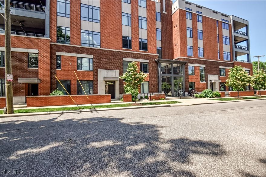 Experience sophisticated urban, yet easy living in this stunning Quattro condominium, ideally located in Cleveland’s vibrant and sought-after Little Italy neighborhood. This beautifully customized 3rd floor unit boasts an open-concept floor plan, luxurious bamboo flooring throughout, and expansive south-facing windows that bathe the space in natural light while offering charming street views. Step into a warm and contemporary great room featuring a stylish fireplace on the north wall and breathtaking city views on the south. The adjacent dining area flows seamlessly between a spacious private balcony and a show-stopping kitchen. Designed for both everyday living and entertaining, the kitchen features trend-forward finishes, double ovens, a gas cooktop, quartz countertops, and a walk-in pantry to envy!!  Enter the library/study through modern yet rustic custom barn doors.  This space is adorned with floor-to-ceiling built-in bookshelves and a custom rolling library ladder. The private owner's suite is located on the SE side of the unit and includes an impressive walk-in closet and a luxurious en-suite bath with a walk-in shower, dual sinks, and private water closet. Two additional bedrooms, a full bath with tub/shower combo, and a generous linen closet are located on the opposite side of the unit.  A dedicated laundry room with cabinetry provides extra storage and offers tons of space for ideal organization. Refined and cohesive design choices in fixtures, hardware, and paint create a seamless and modern, yet warm aesthetic. This home includes two secure, heated, underground garage parking spaces, elevators and is tax abated through 2034!!!!!Enjoy the best of living in Little Italy—dining, shopping, and transit just steps from your door!