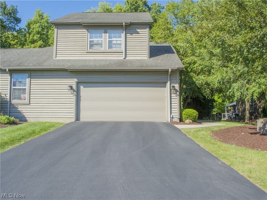 Beautiful, updated Canfield condo in the Tippecanoe Woods development.  This 2 bedroom townhouse features a bright open floor plan with plenty of natural sunlight.  Updated kitchen with stainless appliances and granite.  The living and dining room features a gas burning fireplace with floor to ceiling stone and a sliding glass door that leads to the private deck with a wooded view.  The second floor features a large loft area, laundry room and an additional office space.  This development also features a pool and clubhouse!