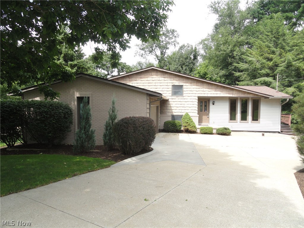 This impressive Twin Lakes 4 level split is uniquely designed and accented with custom woodwork throughout that includes trim, cabinets, shelves, beveled glass doors and beautiful wood and ceramic floors throughout. Warm and inviting with neutral décor. Spacious formal living room, beautifully modernized eat in kitchen with sliding doors in the dining area that lead to the expansive two tiered deck overlooking the semi-private yard and wooded area. Lower level family room with wood burning fireplace, built in shelves and a sliding door to lower level deck. 3 bedrooms 2 full bath plus a bonus room that could be an office or work out room or even a 4th bedroom and there is a walk out basement too! Gas powered back up generator system in place. This home is situated in the Twin Lakes community which includes lake privileges with a beach and dock for swimming , boating and fishing. Must see to appreciate, call today!