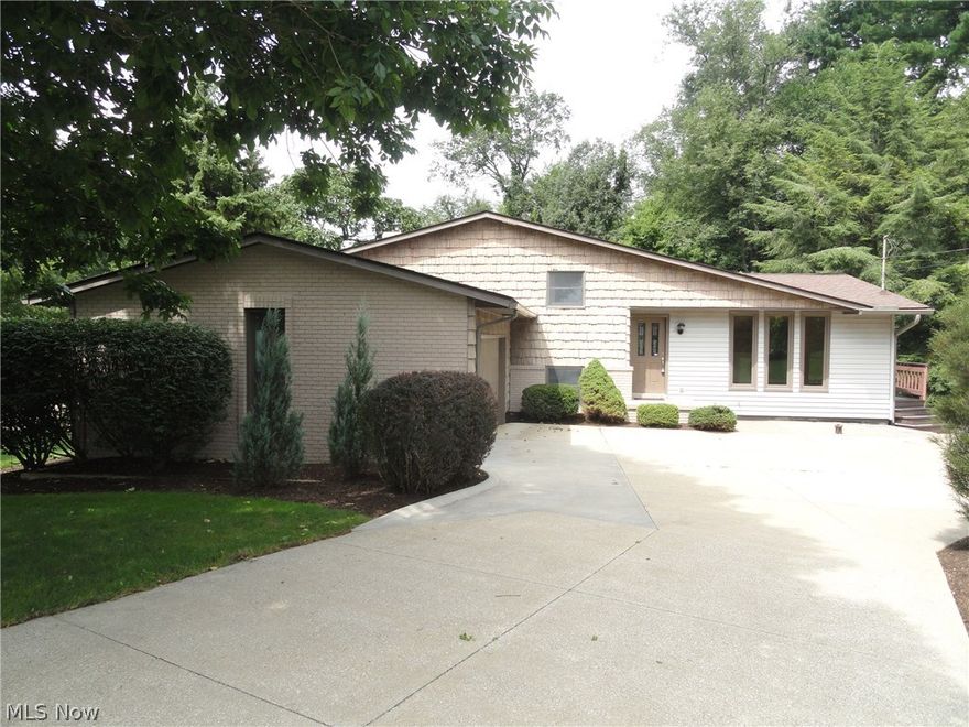 This impressive Twin Lakes 4 level split is uniquely designed and accented with custom woodwork throughout that includes trim, cabinets, shelves, beveled glass doors and beautiful wood and ceramic floors throughout. Warm and inviting with neutral décor. Spacious formal living room, beautifully modernized  eat in kitchen with sliding doors  in the dining area that lead to the expansive two tiered deck overlooking the  semi-private yard and wooded area. Lower level family room with wood burning fireplace, built in shelves  and a sliding door to lower level deck. 3 bedrooms 2 full  bath plus a bonus room that could be an office or work out room or even a 4th bedroom and there is a walk out basement too! Gas powered back up generator system in place. This home is  situated in the  Twin Lakes community which  includes lake privileges with a beach and dock for swimming , boating and fishing. Must see to appreciate, call today!