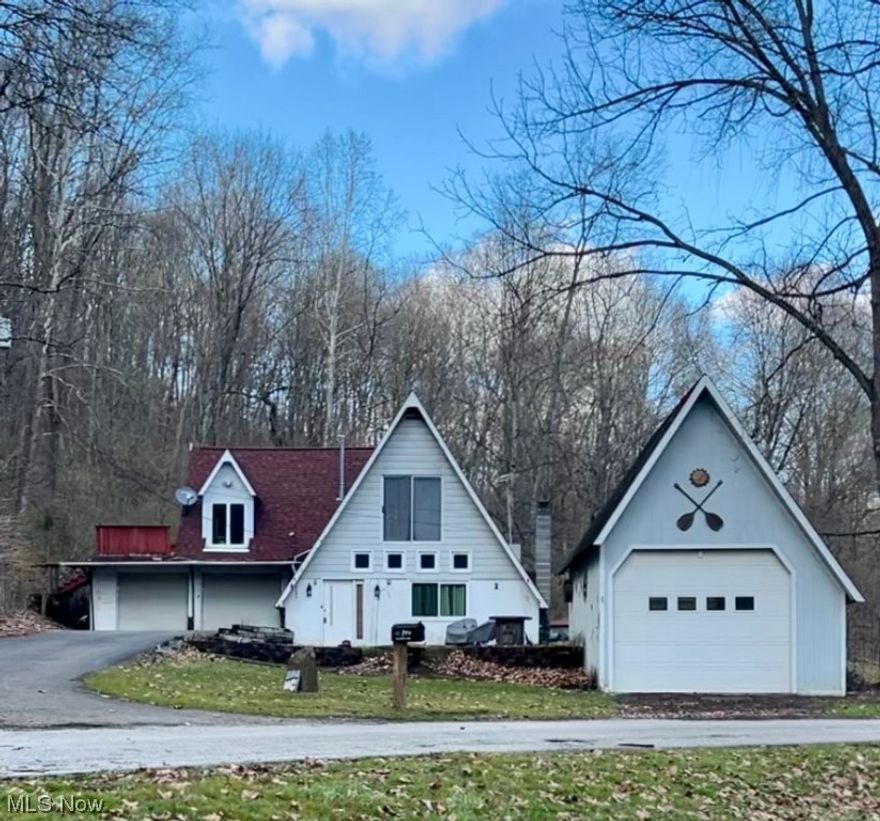 One of a kind! A-Frame home located in a peaceful and private country setting, with beautiful views! The main floor hosts the living room with built-in shelving, tons of natural light beaming from skylights, dinning room, adorable eat-in kitchen with brick fireplace, and bedroom with access to the master bathroom. Two stairways to 2nd story (kitchen and dining room). Upstairs you will find the huge Master Bedroom Suite with bathroom, window seat, and access to deck, and two other bedrooms, one with  beautiful cedar woodwork. Brand NEW roof in 2022. Fenced-in backyard with patio leading to the large outbuilding. Two car attached garage and another oversized detached garage to give you even more space! Make this one yours and enjoy the wildlife!!