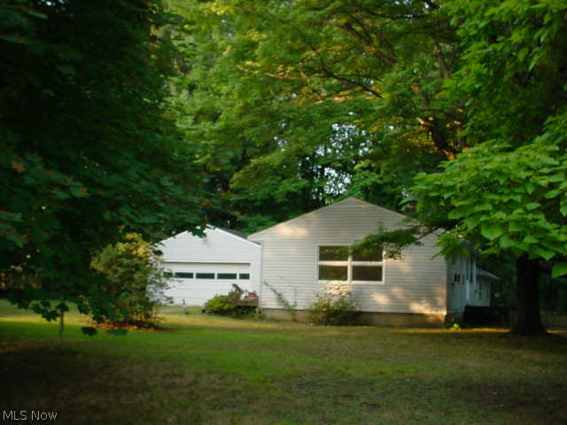 3 bed on double lot w/2+ garage! Needs TLC but great potential! Breezeway, hardwood floors in living room w/slider to deck! Remodeled bath w/laundry hook ups! Roof 2008 & vinyl siding 2013! City water & sewer! Partial basement. No FHA unless 203K.