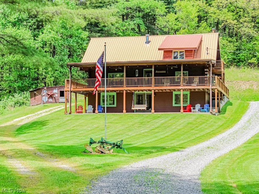 AMAZING GETAWAY LOG CABIN.  You will not want to leave the wonderfully secluded retreat nestled in the woods.  As you drive 1/2 mile off the road back to serenity you are met with a wonderful picturesque hill including a big stocked pond in front of this beautiful log cabin home. There is a heated pole barn/garage next to the cabin.  Also there is a cute horse stahl that could fit two horses.  
There are trails all over to Ride Quads.  
The decking that wraps the entire cabin is newer rebuilt decking.  This log home has 3 nice sized bedroom with a large loft that is functioning as the 4th bedroom.  There are 2 1/2 up to date baths for your family and visitors comfort.  All appliances stay and are brand new 2021.  Also, there are newer TVs that will stay.   Some furniture also stay to help make the move easier. The furnace and A/C are brand new 2021.  New chandelier in the eat in kitchen.  All plumbing in the kitchen was re-done in 2021.  Free Gas on the property and royalties will Co