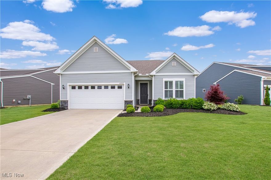 Why Build?  This Ranch in Emerald Woods is better than new!  The lawn and all the flowerbeds were professionally installed, and you will love all the window coverings!  It was built in 2021 and is available for immediate occupancy.  It offers a very open floor plan with 2,035 sq ft of above-ground living space plus a large covered back patio. There are 2 bedrooms, 2 full baths, and an office that could be used as a 3rd bedroom.  Once inside, notice the neutral decor, custom plantation blinds on all the windows, and LVT that leads you back to the main living space, which is perfect for entertaining. The kitchen features white cabinets, granite countertops, white subway tile backsplash, a large breakfast bar with sink, a stainless-steel gas stove top, a built-in wall microwave and oven, plus a stainless-steel refrigerator. The dining area is off the kitchen and has access to the covered patio, making indoor or outdoor dining easy.  This patio was extended by the owner to be an L-shaped patio with a ceiling fan and light built in.  It provides enough space for a sitting area as well as a grilling area.  The family room is open to the kitchen and features tons of windows bathing the room in natural light.  The focal point of the family room is the stone gas fireplace.  Off the main living area is the spacious master suite.  The large master bath features a tiled walk-in shower, a double vanity, and a large walk-in closet.  At the front of the home is the 2nd bedroom with ample closet space plus the other full bath. Completing the main level is a mud room and a laundry room off the attached 3-car garage. The washer and dryer are included.  The lovely home is move-in ready and just waiting for new homeowners!