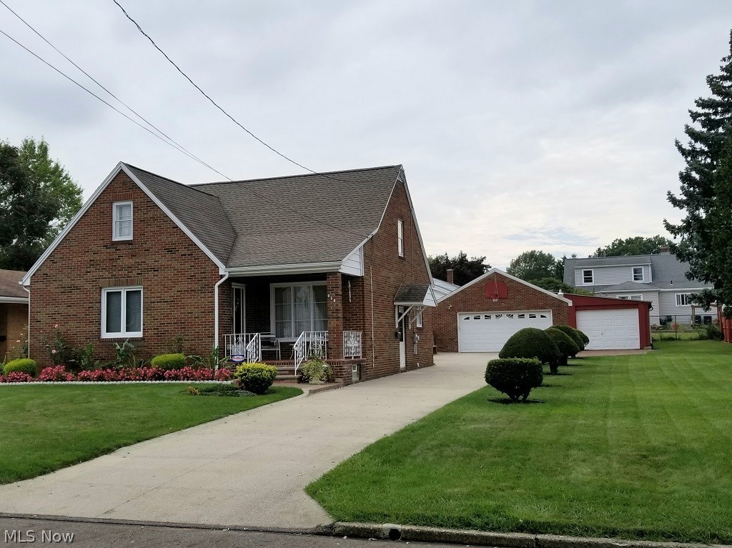 Meticulously kept, all-brick Cape Cod in one of North Hill’s premier neighborhoods. This home is filled with extras! The spacious living room is light, bright and will amply hold multiple couches and chairs, for company. The updated kitchen has gorgeous refaced cabinets with oak cabinet doors, solid surface countertops, newer appliances and tile floor. First floor bedrooms have exposed hardwood and nice closet space. The upstairs has a big bedroom with two big closets and a bonus room perfect for out of town guests, and you’ll love the convenience of a bathroom, with a shower, on every floor! If you hold regular family dinners, this is the house for you! The right dining room table can extend into the den comfortably to serve 15-20 people, and at the holidays the owners served even more in the family rec room! If you like to can, or prepare special foods, the downstairs has a stove and a large area perfect for everyone to pitch in and help, and when you’re done there are three fruit cellars for storage! The roof, furnace, A/C, and electric panel have all been updated. Outside is an amazing yard. The extra wide lot is perfectly groomed, there’s a nice patio that looks into a wonderful fenced in garden. There’s even a stove for outdoor cooking that doubles as a potters bench. There’s a two-car garage and a third, perfect for construction materials or tools, and the driveway is super long for extra cars and lots of company. You’ll know this is the house the moment you walk in!