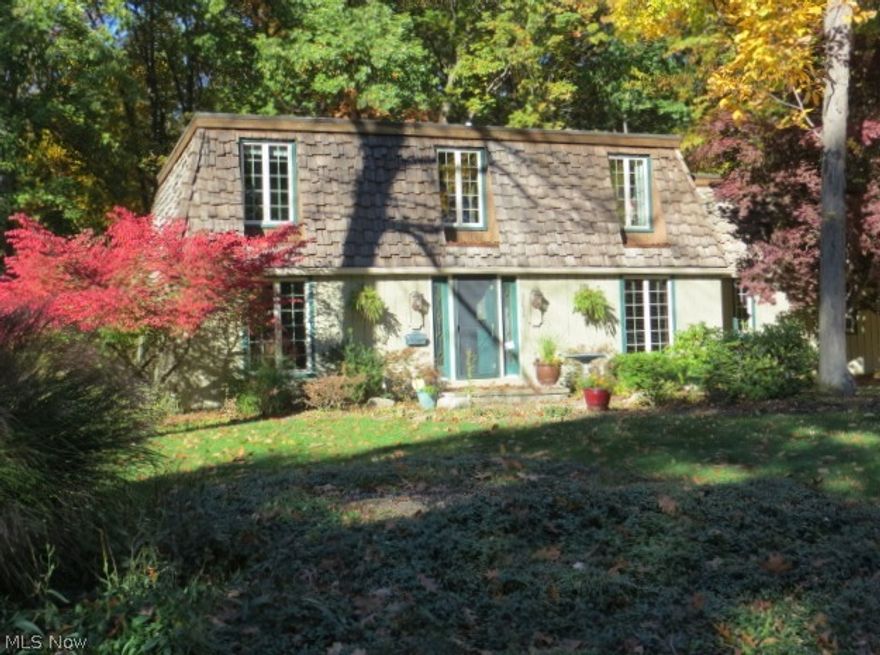 Not the usual colonial with mansard styling.  One owner home with tons of updates, an addition added Gathering Room on first level that includes a wet bar & wine refrigerator  and 2 extra bedrooms on second level. All windows replaced, newer furnace and air conditioning, remodeled kitchen with granite and newer appliances, LR/Den with built-in shelving, hardwood floors in FR/LR, and finished lower level for office or playroom.  Brick paver patio and storage shed.  Private treed backyard adjacent to high school property. Loaded with TLC!  Looks are deceiving as interior is much larger than it looks from the curb!