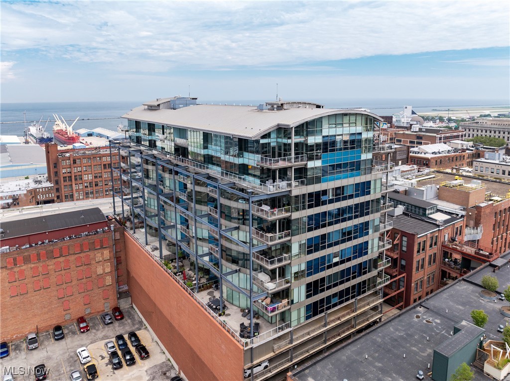 The perfect summer starts here—on a 1,200-square-foot private terrace perched above Cleveland’s dynamic Warehouse District. Welcome to Unit 606 at The Pinnacle, a one-of-a-kind residence with floor-to-ceiling, curving glass walls wrapping the entire southwest corner of the building. Bathed in natural light and offering panoramic lake and skyline views, this home defines elevated city living. The open-concept great room, entirely encased in glass, creates a breathtaking setting for both everyday living and unforgettable entertaining. Step outside to the massive terrace—remarkably private and designed for true indoor-outdoor living. Host dinner parties under the stars, lounge with friends in multiple seating zones, grill year-round, and cultivate your own city garden oasis. Inside, the thoughtful layout continues with large bedrooms, three full baths, and expansive walk-in closets. Every room features a wall of windows, bringing in stunning views and light from every angle. Elegant finishes include oak hardwood floors, custom tilework, and refined stone surfaces. A generous utility room and recently updated mechanicals offer peace of mind. Located in one of downtown Cleveland’s most vibrant neighborhoods, you're just steps from award-winning restaurants, the Flats East Bank, and top-tier nightlife. Stroll to Browns games, take in an evening at Playhouse Square, or cross the bridge for a night in Ohio City or Hingetown. Full-service amenities at The Pinnacle include a luxury fitness center overlooking the harbor and stadium, men's and women’s saunas, 24-hour security, and concierge-style living as well as a dedicated pet area for your furry family members. Two deeded parking spaces are included. This is the only residence of its kind in the building—and one of the most exceptional terraces in all of downtown.
