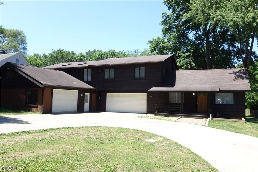 "Extraordinary Rustic Charm" w/a contemporary flair inside & out plus a bonus: A Heated attached garage w/2 steel beams & room for multiple vehicles--motorcycles--etc, plus a jumbo workshop that could be finished into more living space if desired** This Unique & fabulous floor plan throughout has separate living quarters and/or a private office w/3 skylights & its own laundry room, a bedroom, a full bath and a delightful huge 2nd kitchen w/an island in the jumbo family room all located above the garage** Very Roomy & beautiful home that offers all New flooring and freshly painted decor throughout w/ many updates has 4 bedrooms total--3 full & a 1/2 bathroom(s)-- 2 kitchens *See Broker Remarks*--2 laundry rooms and so much more**A Jumbo concrete driveway w/ plentiful parking, plus A wonderfully large back yard**Walking distance to Firestone Metro Park(s) & the World Famous "Firestone Golf Corse", just minutes to Portage Lakes State Park w/public boat launches and "Turkeyfoot Golf Course