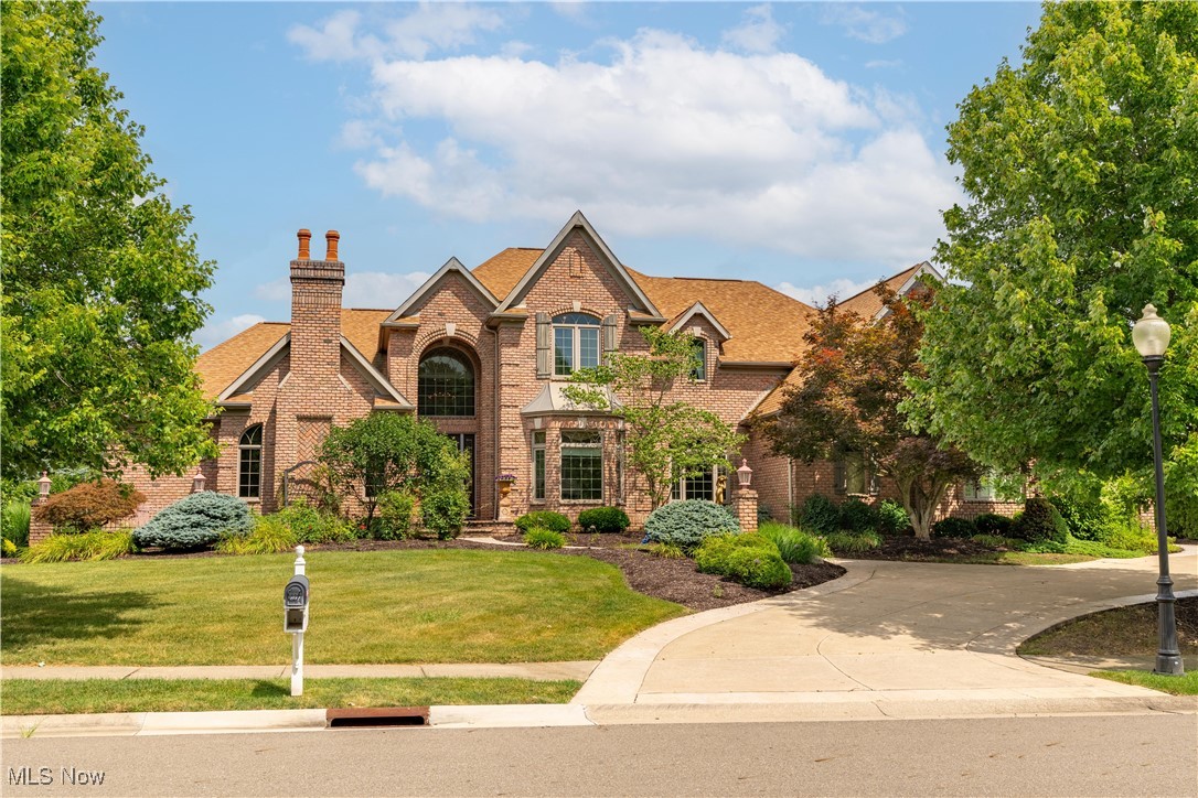 Welcome to this exceptional custom built residence, nestled in the highly coveted neighborhood of Monticello. This all brick, 6,948 sq. ft. prestigious home sits on a beautiful 1.13 acre lot. As you enter the front door a grand 2 story foyer welcomes you with a stunning Swarovski crystal chandelier that seamlessly flows into the great room that boasts 18' ceilings, a wall of windows, a fireplace and beautiful hardwood floors. A gourmet kitchen with granite countertops, KitchenAid appliances and a patio door leading to a multilevel patio that makes it ideal for entertaining. There is an expansive formal dining room, a home office with a fireplace, a 1/2 bath and a first floor laundry room. A luxurious first floor owners suite features a fireplace, a glamorous en-suite bath with his/her walk in closets and connects to a secluded private patio. The second floor consists of three large bedrooms with walk in closets and two more full baths. A full basement includes a huge rec room with a wet bar, full kitchen, granite countertops, a fireplace and a built in entertainment center, along with an exercise room, a full bath and a bonus cedar lined room ideal for a wine cellar. There is an oversized 3 car heated garage with Nature Stone flooring. The roof, windows, 2 high efficiency furnaces, 2 A/C units and 2 hot water tanks are all less than 5 years old. The old world quality craftmanship and attention to detail make this home an exquisite living experience for your family to enjoy for years to come.