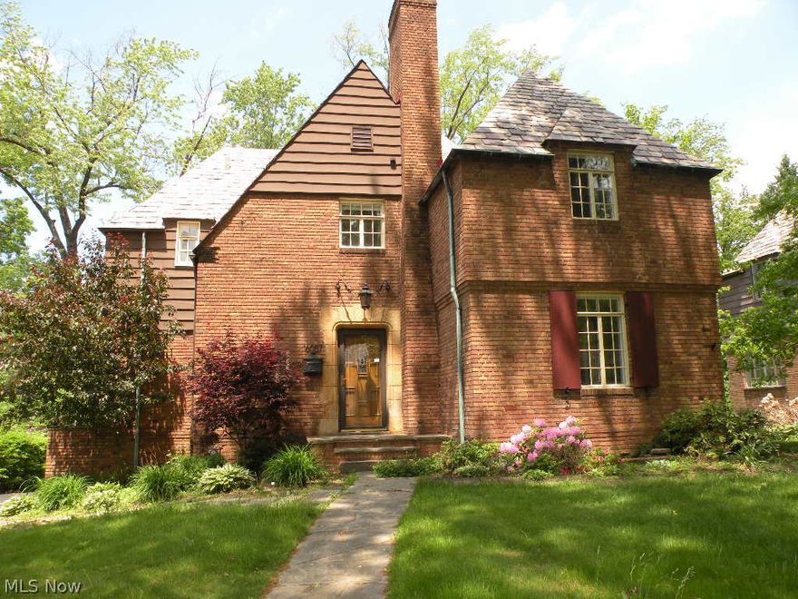 Brick French Normandy Rockefeller in Historic Forest Hill District. One of the 81 homes built by J D Rockefeller II on former estate of John D Rockefeller (Forest Hill). Near Forest Hill Park.  National Register of Historic Places. Living room with built in shelves and fire place. Lots of potential!!!  Bring this beauty back to life. Sold as is. Buyer to assume city violations.