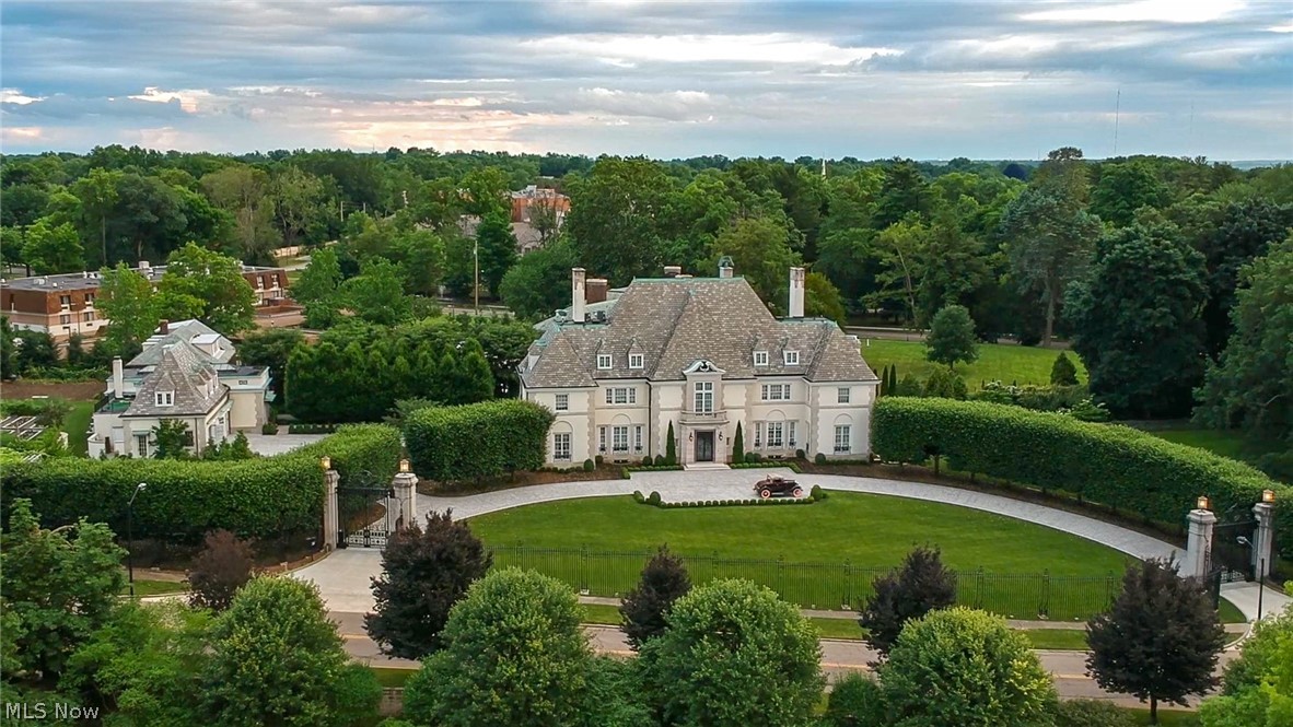 Neo-Classic French Chateau in the Rubber Capital of the World. In 1926 Harvey S. Firestone, Jr., the son of the founder of the Firestone Tire & Rubber Company commissioned nationally known Boston architect Charles R. Greco to build his residence. The interiors of the Firestone estate are studies in chaste refinement and elegance. Mrs. Firestone interest in the traditional French decorative arts brought definition to this space. The generous entrance hall, its dramatic staircase delineated by ornamental wrought iron, leads to the principal first-floor rooms, all in the manner of Louis XVI in the style of Versailles. There are exquisite antique marble fireplaces with delicately detailed gilded over-mantel mirrors, and richly embellished crown mouldings and architraves. In all, the Harvey S. Firestone, Jr. house exemplifies the very best of period-revival thinking. It must be considered one of Akron’s great residences of any period, significant for its architectural design, the importance