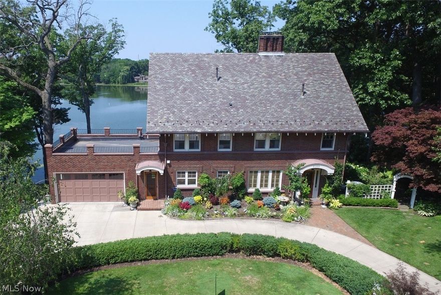 Timeless elegance graces this exceptional Silver Lake Estates lakefront English Arts and Crafts! Masterfully built in 1925, meticulously maintained &  updated with careful attention through design and decor to maintain the stately & graceful ambiance of homes built in the early 1900's. Step into the foyer entry to see  the original oak hardwood floors,moldings and trim work beautifully restored throughout the whole house! Elegant formal dining rm is open to the custom designed gourmet kitchen with cream cabinets & beautiful black granite counters. Expansive formal living rm & sun rm encompass 4 sitting areas & fireplace all surrounded by oversized windows providing an unobstructed magnificent view of Silver Lake. 2 open staircases lead to the 2nd floor where you'll find 3 bedrms and 2 full baths. Master suite includes master bath & sitting room with fireplace, all with full lake view. Full size open staircase leads to 3rd floor w/ 25x15 sitting rm,4th bedrm & full bath.Lower level includes cozy family rm w/fireplace, more gorgeous woodwork,wet bar,wine cellar,utility room,1/2 bath. This level walks out to a covered stone patio overlooking the backyard which has been completely cleared,regraded & redesigned for optimal use, beauty & enjoyment. Extensive stone work,multiple lighted  terraces, stone stairs & paths leading through splendid grounds w/rich mix of lush plantings & flowers all gradually descending to the grassy green lawn on Silver Lake where peace & serenity abound!
