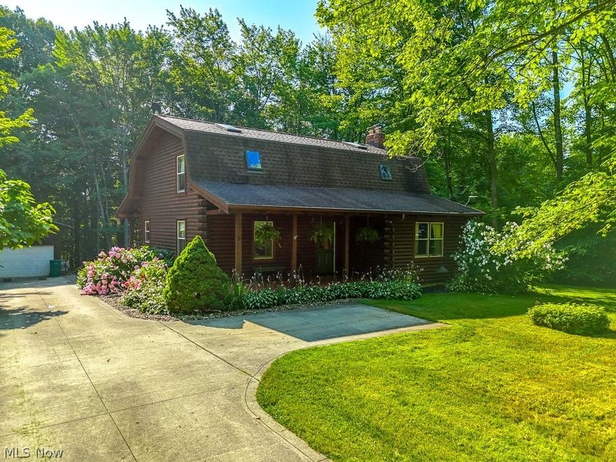 Welcome to this absolutely charming Log Cabin home just minutes away from the award winning Kenston Schools. Enter through the covered front porch into the large great room with vaulted ceilings, wood floors, an amazing wood burning stove fireplace with a custom 2 story stone wall. A large eat in kitchen has wonderful wood cabinetry, lots of counter space and room for a large dining room table.  The first floor bedroom has private access to the first floor full bath with sitting tub.  Walk up the open staircase to the second floor loft with skylights overlooking the great room welcoming lots of light.  The second floor master bedroom has a custom walk in closet, and a large updated glamour bath with spectacular custom stone shower and tile.  An unfinished lower level is perfect for you to put your finishing touches. walk out to the covered rear porch to a private, peaceful backyard.  This home is situated on a private 2.83 acres with beautiful custom landscaping, and retaining wall with built in lighting .  The detached 2 car garage offers conduit lines for gas, water and internet. And a whole house generator.