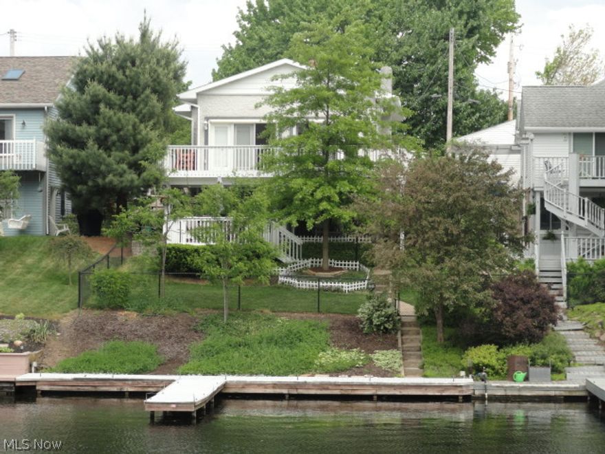 Vacation year round from this lake front home in beautiful Portage Lakes!  Both levels of this 2-story home have glass doors across the back that step out to deck porches for you to sit and enjoy the lake view or follow the path to the fenced yard, seawall and private boat dock.  Extensive updates include carpet, newer roof, windows, electric, plumbing, septic line, insulation, ceiling fans, water heaters, and more!  The remodeled kitchen includes new cabinets, counters, floors, lighting and top grade appliances.  Lower level has heated floors for extra comfort if needed and there is two gas fireplaces.  Hot tub included.  Don't hesitate, call today!