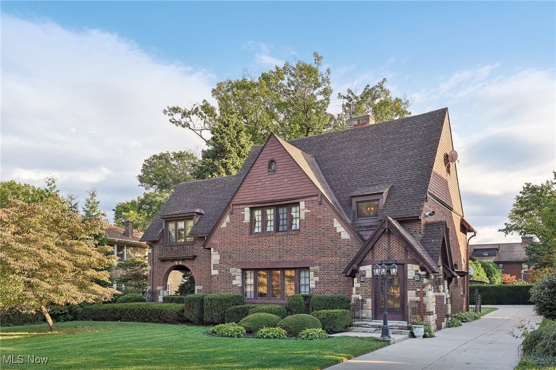 Unique opportunity as homes are rarely offered for sale on Edgewater Drive in Cleveland. This 4 Bedroom / 2.5 Bath brick Colonial style home was originally built in 1923 is just steps to Edgewater Park and Lake Erie. Set in one of the prettiest and historic neighborhoods in Cleveland, this street is very quiet, tree lined and is perfect for walking or cycling to enjoy the beautiful views! As you walk-in you will be taken by the amazing woodwork, curved doorways, and quality of construction and design details that are hard to find today. The Living Room is spacious (25’ x 17’) and features a wood-burning Fireplace with mantle and gorgeous wood crown molding and beams. The formal Dining Room is open to the Kitchen and Living Room which is great for entertaining family and friends. Just outside the Living Room is a beautiful stone patio to enjoy the outdoors (and could easily be made into an Outdoor Kitchen). The eat-in Kitchen has plenty of counter and cabinet space and pantry storage. The first floor also features a half bath for convenience. As you head upstairs, you’ll love the spacious Owner’s suite (16’ x 13’) that has an adjacent Sitting Room or Den (16’ x 15’), giving you plenty of space to relax. The main bathroom is luxurious with gleaming white tile, a pedestal sink, walk-in shower, and soaking tub. The second floor features an additional two bedrooms with nice size closets. Head on up to the 3rd floor and you’ll find the 4th Bedroom and a full Bathroom with a walk-in shower. Hardwood floors under all carpeted areas of the home. Full unfinished basement. Premium quality Rudd H2O tank. Two car brick detached garage. Fully fenced yard. Inground Sprinkler System. You’ll love being steps to Edgewater Park with its walking & bike trails, beach, concerts, water sports, and yacht club.