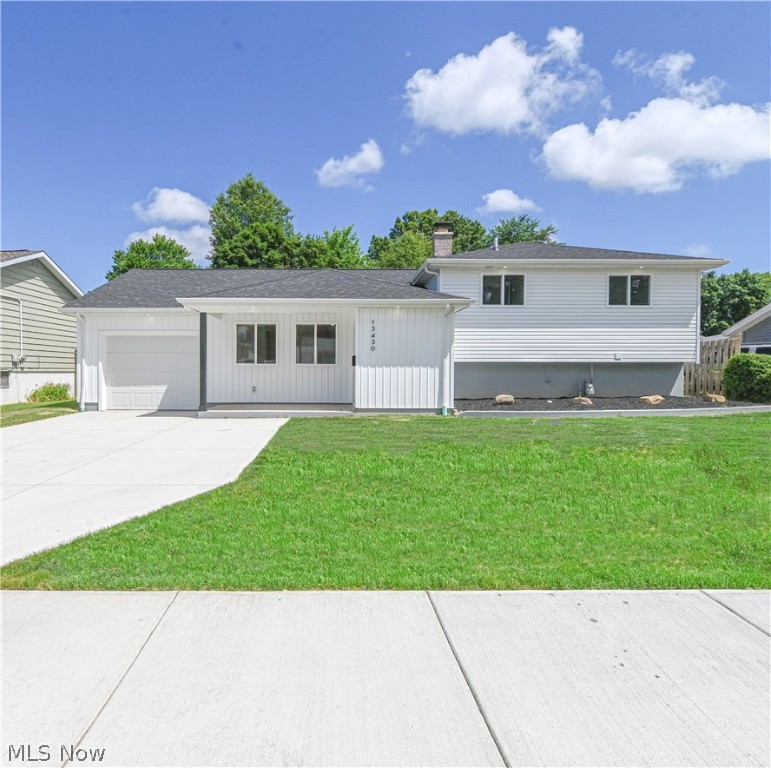 Be enamored by its welcoming appearance as you enter this fully redesigned and stunningly attractive split-level style home. With its curb appeal and fresh landscaping, this home offers a truly memorable first impression. The exterior boasts a double-deep garage and new concrete amenities: back patio, garage floor, sidewalk, and extra-wide driveway with ample parking. New roof shingles, gutters, vinyl siding, exterior doors, and a patio sliding door with built-in blinds are just a few of the amazing upgrades this home affords. The spacious backyard is complemented with a front yard covered porch adorned with board & batten vinyl siding and LED soffit lights, creating a warm and inviting entrance. In the first-floor open concept, you immediately notice the great pride and fine craftsmanship of its upgraded details, including a custom bench and vaulted ceilings. The kitchen is yet another highlight of this home, boasting new appliances, cabinetry with crown molding & soft-close technology, white subway tile backsplash, quartz countertop, and plenty of storage options. The gourmet serving island creates a chef's haven, where you can unleash your culinary skills and create delicious meals to be enjoyed by friends and family alike. The interior is further enhanced with new windows, solid trendy doors, modern trim, glass block windows, LED lighting, and new floors throughout. The second floor offers 3 bedrooms and a glamorous full bath. The lower level features an expansive family room, perfect for relaxation or entertainment. The stylish full bath on this level includes a tub and shower. This captivating home also boasts a new HVAC system and a new hot water tank, ensuring lasting comfort and convenience. To top it all off, this property comes with a 10-year tax abatement, providing still more financial benefits. Do not miss out on the opportunity to make this uniquely attractive home yours. Schedule a showing today and discover the comfort and beauty it provides.
