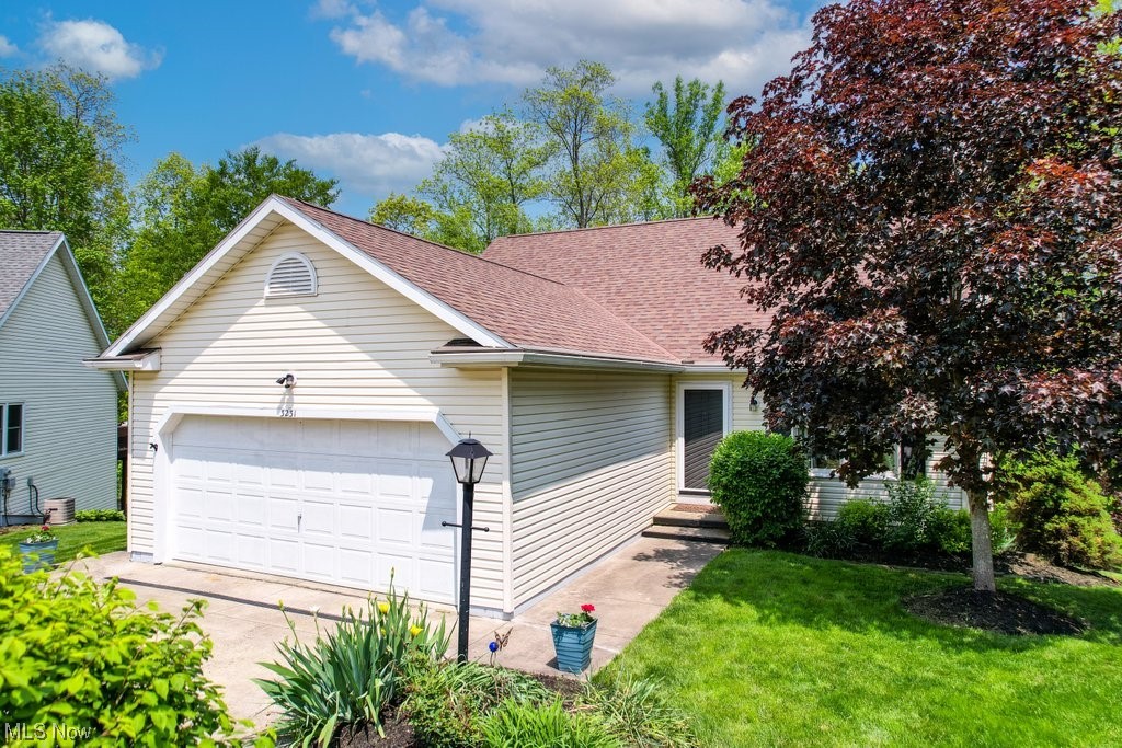 Delightfully updated 3 Bedroom/2 Bath (with a possible 4th bedroom) spacious condo on a private cul-de-sac is just minutes away from Kent State University and NEOMED! You’ll love this open and bright home with plentiful windows, neutral paint, 2 car attached garage and newer vinyl plank floors throughout the entire first floor. The large and inviting living room boasts a beautiful stone fireplace and cathedral ceilings and flows into the dining room with glass doors that lead to a large deck overlooking the park-like backyard. The kitchen wows with its abundant cabinets, stainless steel appliances, pantry and large island with additional storage. Two spacious bedrooms are located on the first floor with ample closet space and one full bathroom. Stairs lead down to an adorably updated bathroom with ceramic tile flooring and a walk-in shower. The carpeted lower level features a large rec room with an additional fireplace, a 3rd bedroom with walk-in closet & adjoining bathroom, and a bonu