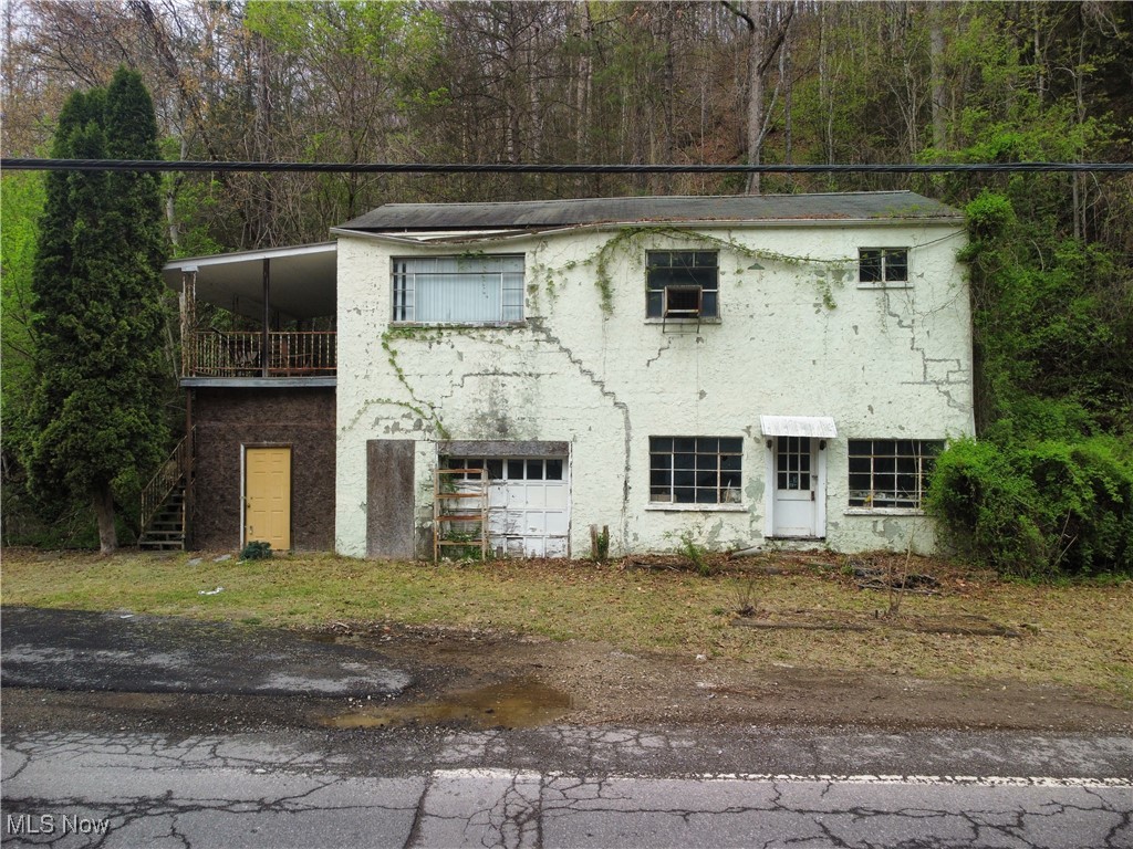 Just ten minutes from the quiet hills of Clay and 45 minutes from the pulse of Charleston sits a building that time forgot—but one that’s ready for a comeback in the right hands.
Once a small-town storefront with an apartment above, this 1950s block-construction building now stands weathered and worn, holding tight to stories of what it used to be. The main floor—once a shop, maybe a garage—is wide open, with high visibility from State Route 4, where 2,000 vehicles pass by each day. The upstairs apartment has two bedrooms, a bath, and a generous living area, all of it waiting to be restored or reimagined.
Let’s be honest: this place is a wreck. The foundation has cracks. The structure needs serious work from the ground up—floors, windows, walls, plumbing, electric. Everything. It is uninhabitable in its current state and will demand both grit and craftsmanship. But for the right person—someone with tools, vision, and determination—this is more than a wreck. It’s a blank canvas with character.
The good news? City water, gas, and electric are already in place. And the property boasts more than 200 feet of frontage on a well-traveled state route, offering commercial potential, rental income, or simply a quiet home project with big upside.
You could renovate. You could rebuild. Or you could start fresh and clear the lot entirely. Whatever the path, the entry cost is low—and the possibilities are wide open.
For the carpenter, the dreamer, the do-it-yourselfer—this is your kind of project.