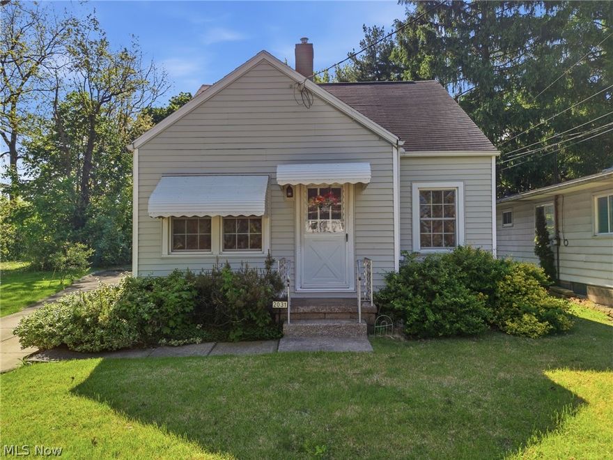 Tucked onto a spacious 1.5 city lot in Akron, this 3-bedroom bungalow is full of charm, character, and thoughtful updates throughout. From the moment you arrive, the beautifully maintained landscaping sets the tone, welcoming you into a home that feels warm, inviting, and truly special. Inside, hardwood floors flow through the living room and bedrooms, adding timeless appeal. The main living space has been opened up between the great room and dining area, creating an easy, connected layout that feels both bright and functional. The eat-in kitchen features brand new flooring, offering a fresh, updated space for everyday living. The full bathroom was completely updated in 2021 and showcases a sleek glass shower with tile surround, blending modern style with comfort. The finished attic bedroom is a storybook retreat, featuring two built-in twin beds with integrated drawers, closets, and storage an incredibly charming and functional space you won’t find just anywhere. The unfinished basement adds even more flexibility, complete with laundry, a convenient half bath, and plenty of room for storage or future finishing. Additional updates include all new electric (2005/2006), giving peace of mind for years to come. Outside, the detached one-car garage includes electric and a new door, while the oversized lot provides extra space to enjoy. If you’ve been searching for a home with personality, charm, and room to grow, this Akron bungalow is one you won’t want to miss.