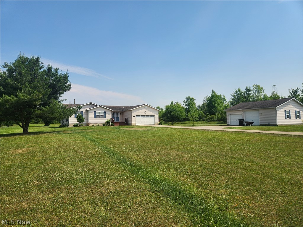 Immaculate ranch nestled on just over 5 acres in the perfect location in Ashtabula County. This home features a huge 22 ft. Living Room with the open floor plan to the the very large 21 ft. Dining Room. The gourmet kitchen looks out to the two tiered deck and over looks the beautiful backyard, garden area, woods and trail to the back pond. The spacious Master Suite offers a large Master Bathroom with a large double his and her sink. There are two more bedrooms with a full updated bathroom. The laundry room is just off the garage. There is a full second kitchen in the basement for all your baking/canning needs. There is an additional extra large 30 x 30 garage for your additional vehicles, campers or toys. The house has a house generator and full concrete driveway. Location is key! In between Rock Creek and Jefferson. Throw a rock and you will be in Roaming Shores. New refrigerator in 2024, septic cleaned in 5/15/23, new double doors in 2021, microwave in 2022, gas stove in LR in 2020, new HVAC system in 2021, Hotwater tank in 2021