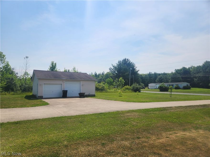 Immaculate ranch nestled on just over 5 acres in the perfect location in Ashtabula County.  This home features a huge 22 ft. Living Room with the open floor plan to the the very large 21 ft. Dining Room.   The gourmet kitchen looks out to the two tiered deck and over looks the beautiful backyard, garden area, woods and trail to the back pond.  The spacious Master Suite offers a large Master Bathroom with a large double his and her sink.  There are two more bedrooms with a full updated bathroom.   The laundry room is just off the garage.   There is a full second kitchen in the basement for all your baking/canning needs. There is an additional extra large 30 x 30 garage for your additional vehicles, campers or toys.   The house has a house generator and full concrete driveway.   Location is key!  In between Rock Creek and Jefferson.   Throw a rock and you will be in Roaming Shores.  New refrigerator in 2024, septic cleaned in 5/15/23, new double doors in 2021, microwave in 2022, gas stove in LR in 2020, new HVAC system in 2021, Hotwater tank in 2021