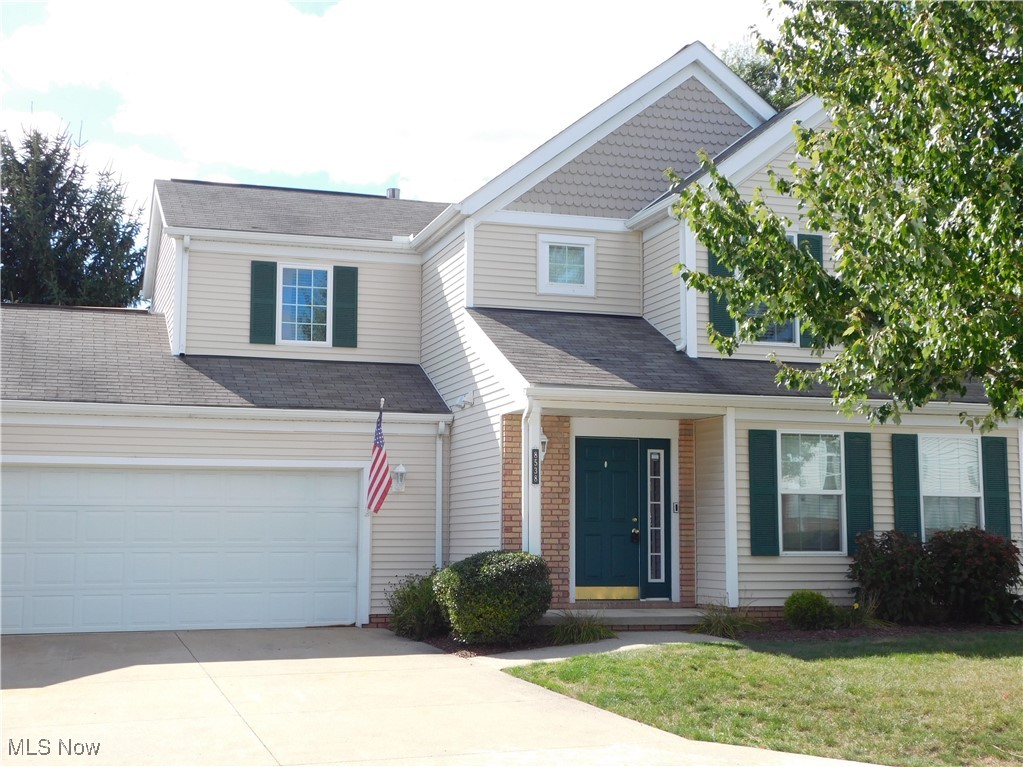 Move right in and enjoy maintenance-free living in this gorgeous Springhill Reserve townhouse. A welcoming front porch opens to a foyer with updated laminate flooring that flows throughout the main level. The bright, open living room leads to a beautiful kitchen with newer stainless appliances, neutral countertops, a breakfast bar and a dinette with sliders to a large deck—perfect for summer entertaining. A convenient first-floor half bath and a laundry room (washer & dryer to remain) complete the main level. Upstairs, the vaulted master suite features two closets and a private bath with a shower and a large vanity. Two additional bedrooms and a second full bathroom round out the second floor. The roomy two-car garage offers ample space for storage and shelving. Community roof replacements are being scheduled. Move in and start enjoying low-maintenance living in this updated home! Stove 2023, Dishwasher 2024, Garbage Disposal 2025, Hot water tank 2023, Ultraviolet bulbs for HVAC purification 2024, Toilet mechanics 2024.