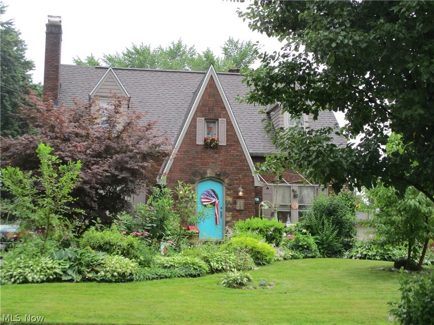Wow you will want to check out this all brick Tudor with so much to offer! As you walk up the sidewalk you will notice all the perennials.  Upon entering the foyer into the living room there is a wood burning fireplace with unique Italian stone. The fireplace can be converted to gas (the pipe is installed). A nice size dining room leads to a large kitchen with a cheery breakfast nook with windows to let the sun in while you enjoy your morning coffee! Also, on the first floor is a master bedroom.  The half bath is an added plus.  There is an updated sunroom addition with Anderson windows and floating wood floor. Also there is a large closet & a french door which leads to a covered cove. Both ceilings are tongue and groove. Upstairs are 2 large bedrooms with an abundance of closet space.  One bedroom has 2 walk-in closets and the other has a dressing room and walk-in closet.  Upstairs is where the updated full bath is located. The large back yard (2 parcels), boasts a 4 car garage with c