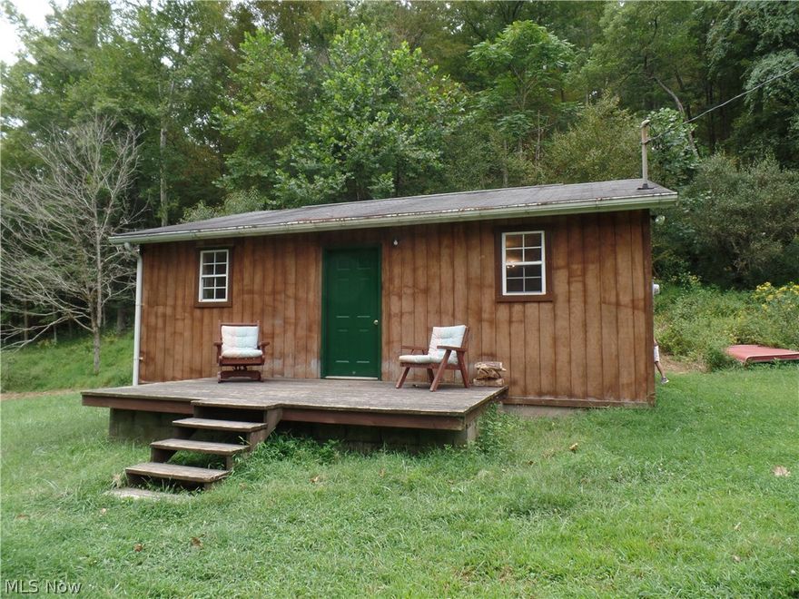 SECLUSION . . . . If you are looking for a nice getaway, then look no further. This hunting cabin is a total of 672 sq. ft. and sits on a beautiful flat lot surrounded by trees. There are 99 acres and of that, there are two cleared and flat bottoms of approximately the size of two football fields. 1/4 acre was timbered in 2012. Sit on the front porch, relax and watch all the wildlife this property has to offer.  See also MLS#4095677