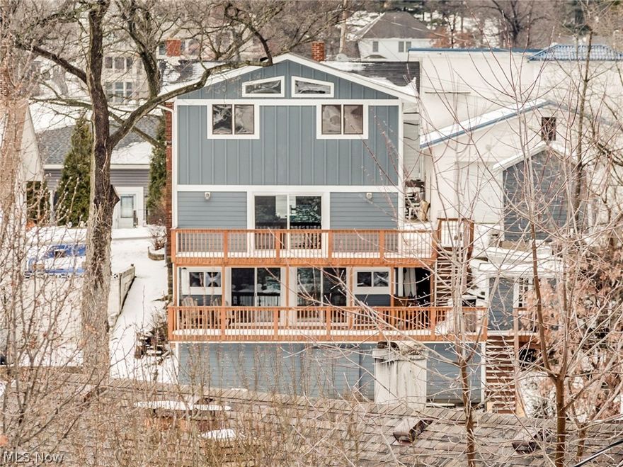 Adorable lakefront on East Reservoir of main chain of Portage Lakes on quiet dead end street with 3 bedrooms, 2 baths, approx. 1850SF including walkout lower level rec room* So many updates including kitchen, bathrooms, floor coverings, sliders and most windows, furnace & A/C (3 yrs.), siding (2 yrs.) & approx. 1000SF of partially covered wrap around deck* Great room with stone wood burning fireplace, double fan & 8' slider to deck overlooking lake* Kitchen with stainless gas range, refrigerator, microwave, Corian counter top with molded sink & pantry* Dining with bay window & built in corner cabinets* 1st floor office or 3rd bedroom* updated  bath with double vanity & porcelain floor* Partially vaulted master & 2nd bedroom with ceiling fans & view of lake* Walk in storage area* 9x5 enclosed mud room* Custom built stair case & handrail from great room to walk out lower level with recreation room, sliders to 16x33 partially covered deck & full bath* Concrete sea wall* Dock* 1 car garage