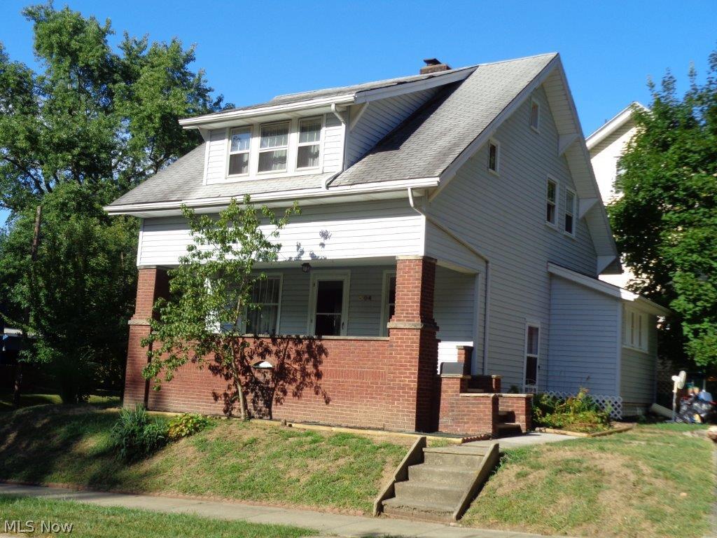 Remodeled in 1970 and nicely maintained this 3 bedroom, 2 full bath home is move-in ready today. Beautiful woodwork, hardwood allergy-free flooring with ceramic tile in kitchen and bath. Lots of kitchen cupboards and counter space, new double stainless steel sink in this bright and cheery kitchen that includes stove, refrigerator, dishwasher, and microwave. Washer and dryer also remain. Gracious floor plan and spacious rooms make for comfortable every-day family living. Charming features with modern updates, very nice light fixtures, brick-gas-start fireplace, and a 5x6 walk-in closet you will appreciate. Bring your favorite relaxation chair for the wonderful 7x23 covered front porch roomy enough to enjoy container gardening. Lots of natural light, all rooms freshly painted, this is a very clean home including basement utility and exercise rooms. The brick and vinyl exterior, insulation, and storm windows provide low utility bills making this home especially affordable. N