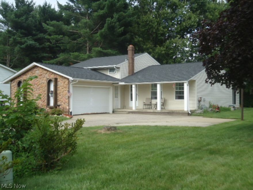 A must see 3 bedroom split level with 2 car attached garage, with an xtra large parking pad; a woods behind the home, home features not only a family room on lower level, but also a bonus family room on the main floor facing the woods in the back.  Home is just under 1900 sq ft of living space.  a new roof was completed in 2009; also a new Hot water tank in 2009, ceiling fans in all bedrooms; there is no wallpaper in this home; house is in great move-in condition. Comes with all the matching kitchen appliances and a year warranty for the new home owners.  also features a front porch.