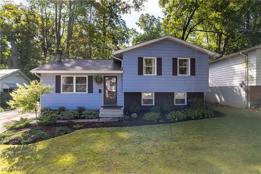 Welcome to this beautifully updated home in the heart of Akron’s desirable Merriman Valley, just minutes from Sand Run Park, scenic trails, coffee shops, restaurants, and plenty of local activity. New roof August 2025. Tucked away in a serene setting, this property offers the perfect blend of convenience and privacy with its wooded backyard that slopes down to a picturesque creek. Inside, you’ll find a bright and welcoming living room featuring a completely redone fireplace, updated flooring, and fresh finishes. The kitchen, fully renovated in 2021, includes a new backsplash, modern cabinetry, stylish counters, and updated appliances—perfect for everyday living and entertaining alike. Upstairs, three comfortable bedrooms and a beautifully updated full bath with a brand-new tub provide restful spaces for family or guests. All new closet doors add a polished touch throughout. The lower level expands your living options with a spacious rec room or second living area, a half bath, storage space, a laundry room, and a utility area. Walkout access makes it easy to step right outside and enjoy the natural setting. This home has been thoughtfully redone from top to bottom with major updates already complete: brand-new roof (2025), new drywall/ ceilings in both living areas and kitchen, new closet doors and bedroom doors. hot water tank (2019), furnace (2016), along with all new flooring, paint, drywall, lighting, and more. Enjoy evenings on the patio, tend to your raised garden beds, or make use of the shed—complete with electric—for storage or hobbies. Fresh landscaping in both the front and rear adds to the home’s curb appeal and outdoor enjoyment. Truly move-in ready, this home combines modern updates with a stunning natural backdrop—ready for you to make it your own.