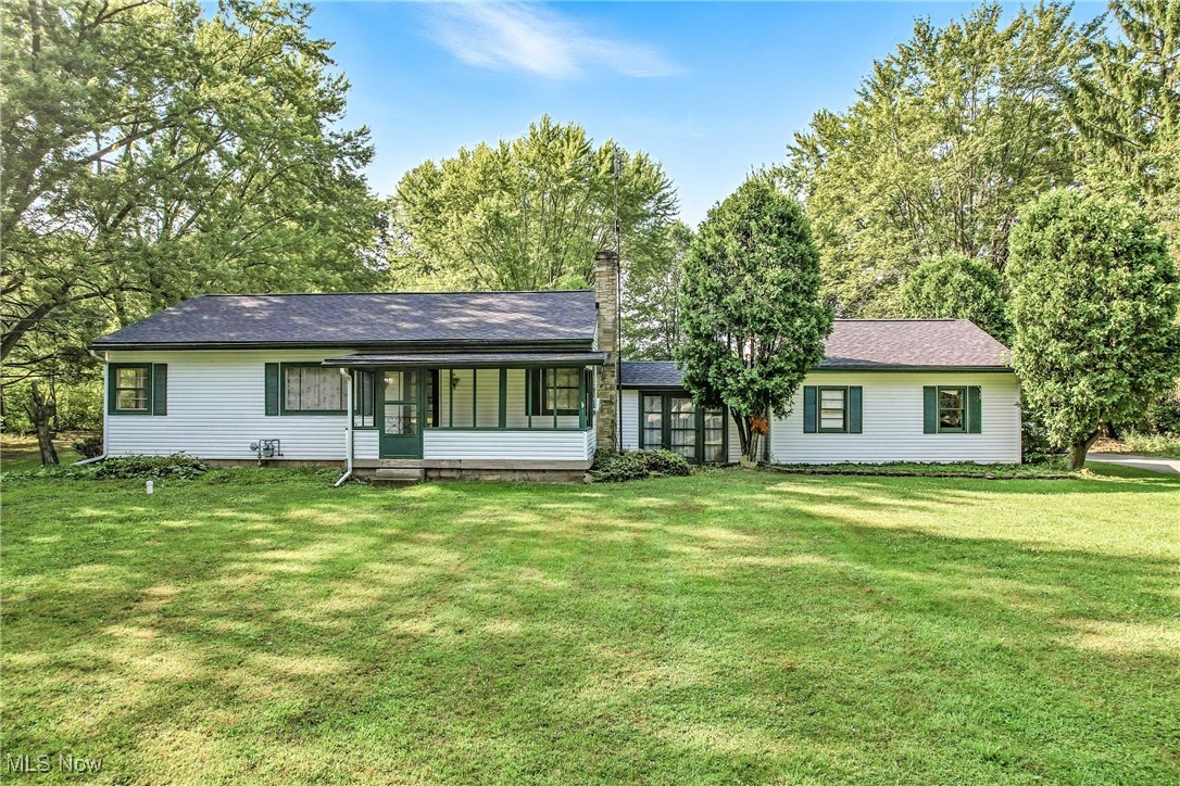 If you're looking for a private setting, this charming 1,040 sq,ft. ranch home, located in the highly sought-after Howland School District, offers the ease of one-level living on a spacious 1.84 acre lot. With no stairs to climb, this 2-bedroom, 1-bath home includes a 14x26 living room featuring refinished hardwood flooring and a wood burning fireplace, with plenty of room for a dining space at one end. There are 2 spacious bedrooms and a partially remodeled full bath, as well as a first floor laundry. The oversized 2 car garage is connected to the home by a finished breezeway that also can serve as living space. The screened front porch at the front of the home is accessed from the living room—great for relaxing or enjoying the peaceful view. The galley kitchen has the original knotty pine paneling with a hidden pantry, range and refrigerator, and a breakfast bar that is open to the living room. While the home could use some cosmetic updates, and a few projects completed, major improvements have already been made: public water service, roof on the home, barn and shed (2024), gutters (2024), electric service upgrade (2023), new septic system (2022),and new drain tile in the backyard (2023). The large, tree-lined backyard also includes a small barn and a storage shed. Great value and potential in a top-rated school district!