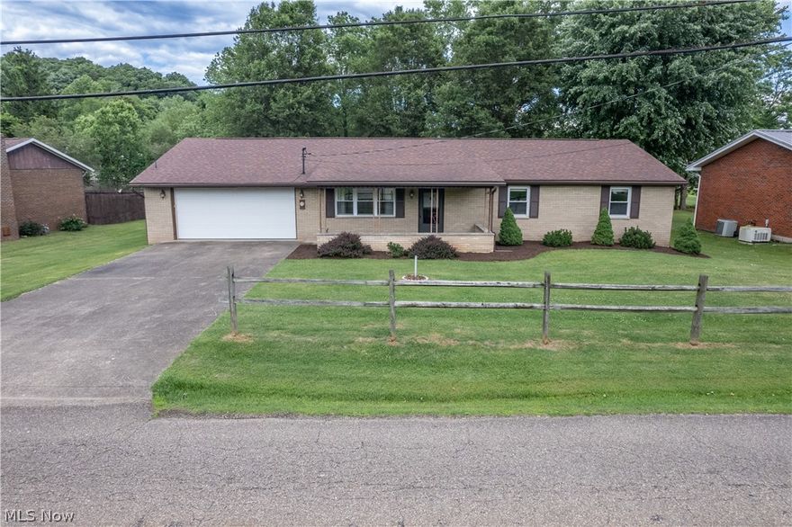 Absolute one-level living with superb accessibility!  This brick ranch home offers so many great features!  The living room includes a large window and gas fireplace, and opens into the dining area and kitchen.  Plenty of cabinet and counter space ensure functionality of the kitchen.  The primary bedroom features it's own en suite, with a roomy 48"x60" custom tile shower.  Two other large bedrooms are across the hall, with another full bathroom adjacent.  The extra wide 46" hallway and 36" interior doors accommodate those with current or future accessibility needs, and there are no steps AT ALL from garage to porch to house and throughout the home all the way onto the back porch.  Unless going down into the back yard, you'll never have to worry about navigating any steps!  Just off the kitchen is a double garage and laundry.  The oversized utility room offers ample space for storage, with an outbuilding in the back yard for even more room.  The back yard is fenced, with additional lawn space to the small meandering creek behind.  The front and back covered porches will host refreshing outdoor retreats in the mornings and evenings, and the large flat lot and tan brick exterior offer minimal maintenance and timeless curb appeal.  Located in an established neighborhood, this home offers convenience to the highway, shopping, dining, and healthcare.  This rare fully one-level home with accessibility needs fully incorporated in the design is ready for the next owner to enjoy the confident and easy lifestyle it offers.