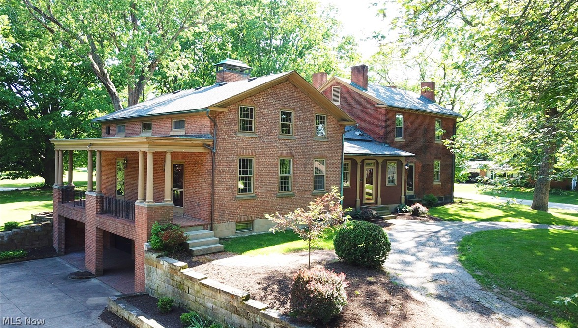Stunning historic brick home restored to perfection! Features 6 gorgeous fireplaces, 5 spacious bedrooms, 3 full baths, kitchen with eating area, formal dining room, parlor, family room with walk in fireplace, and library! Rare and unique early twentieth century library made by Tiffany Studios, New York (famous maker of Tiffany Jewelry, lighting, stained glass windows, and interiors). Provenance – purchased from former Firestone Mansion (Harbell Manor) of Harvey Firestone, founder of Firestone Tire and Rubber Company, Akron, Ohio. This paneled room has quarter sawed oak, pegged teak floors, original stone mantel, original lead glass windows and doors, and original light fixtures. Library was visited by many notables such as; Thomas Edison, Henry Ford, and several presidents. Rooms boast special detailed molding. Enjoy a covered rear patio overlooking a gorgeous manicured yard with outbuildings. Also included is a covered side yard patio, a two car attached garage, three car detached ga
