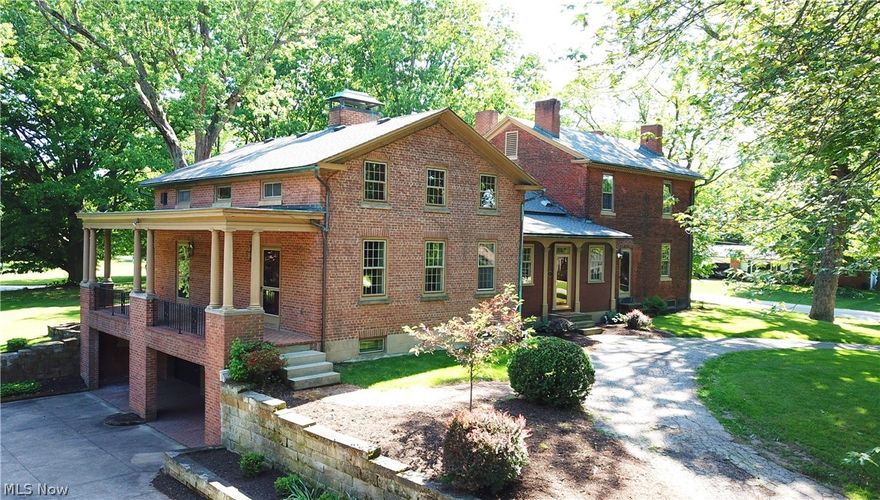 Stunning historic brick home restored to perfection! Features 6 gorgeous fireplaces, 5 spacious bedrooms, 3 full baths, kitchen with eating area, formal dining room, parlor, family room with walk in fireplace, and library! Rare and unique early twentieth century library made by Tiffany Studios, New York (famous maker of Tiffany Jewelry, lighting, stained glass windows, and interiors). Provenance – purchased from former Firestone Mansion (Harbell Manor) of Harvey Firestone, founder of Firestone Tire and Rubber Company, Akron, Ohio. This paneled room has quarter sawed oak, pegged teak floors, original stone mantel, original lead glass windows and doors, and original light fixtures. Library was visited by many notables such as; Thomas Edison, Henry Ford, and several presidents. Rooms boast special detailed molding. Enjoy a covered rear patio overlooking a gorgeous manicured yard with outbuildings. Also included is a covered side yard patio, a two car attached garage, three car detached ga