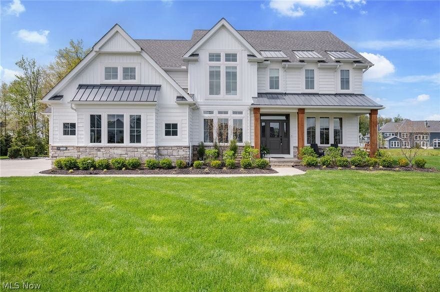 Set on .35 of an acre property in Avon Lake’s South Port community, this breathtaking home is designed for elevated entertaining & everyday enjoyment, inside and out. The outdoor living experience includes professionally designed landscaping, spacious patio w/ built-in firepit & wood bench seating, western red cedar deck w/ custom pergola & lighting, turf putting green & meditation garden. Inside, over 4,659 sq ft of thoughtfully designed living space unfolds w/ refined finishes & intentional detail throughout. A dramatic 2-story great room w/ a wall of windows fills the home w/ natural light, anchored by a fireplace w/ marble surround & a striking 2-story Venetian plaster accent. The open layout flows into a curated kitchen & dining space, w/ Taj Mahal quartzite countertops & backsplash, Shaker cabinets, white oak shelving, matte black stainless steel appliances & custom hood, large island w/ seating, a coffee bar & walk-in pantry. A 4-panel sliding door connects to the outdoor oasis. The main level also includes a den, 1st-floor bedroom w/ en-suite bath & an expansive laundry room w/ custom built-ins. The primary suite offers a true retreat w/ tray ceiling & spa-like bath w/ double vanity, pebble tile accent wall, soaking tub, Roman shower & a 15’ walk-in closet. Additional bedrooms feature custom built-in bunk beds, walk-in closets & a vaulted suite w/ its own bath, all complemented by upgraded finishes throughout. The finished lower level is equally impressive, w/ a custom wet bar featuring a honed stone bartop & built-in live-edge wood-top console, a spacious lounge w/ electric fireplace & custom live-edge walnut bench, fitness area & additional space for a media room, rec room, or other living space. A welcoming front porch w/ swing, attached garage w/ 2-car side entry & an additional 1-car bay w/ a 9-ft door & an extended parking pad add to the home's thoughtful design & function. Many updates completed - a detailed list is available upon request.