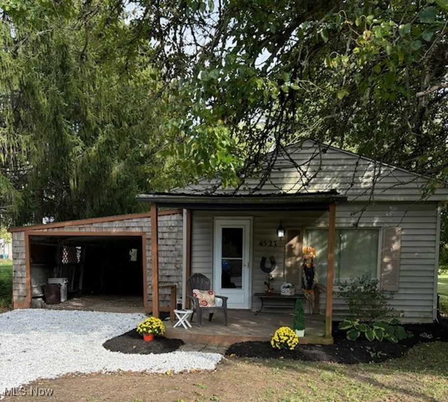 Charming open-concept cottage featuring 1 bedroom and 1 full bath. This home offers an attached carport plus a detached 1.5-car garage, all set on a half-acre, partially wooded lot. Utilities are in good working condition for peace of mind. Major updates include a new roof (2021) and new hot water tank (2020). Cozy, functional, and full of potential.