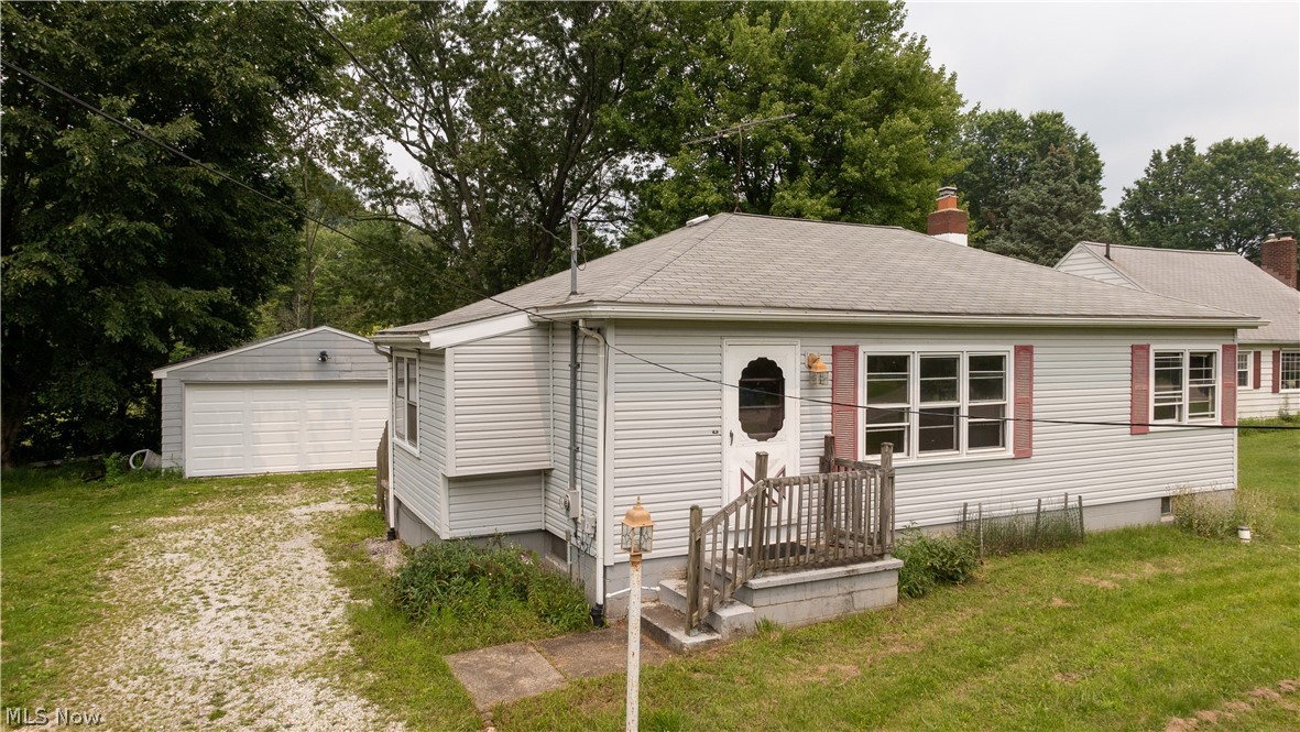 1967 E Turkeyfoot Lake Rd Akron is a great layout ranch home in the Green Local School District. 1st Floor Living for ease includes spacious Living Room, Eat-In Kitchen, Side Porch mud room entry from drive, 2 beds, 1 bath & large basement with laundry room & oversized detached 2-car garage with newer overhead garage door on almost acre lot on 2 parcels includes 107 ft frontage and is 353 feet deep. Newer carpeting throughout the living areas & the eat in kitchen has lots of cabinetry and there is a mud room leading to the large back yard. The partially finished basement, with Ohio State Waterproofing has a transferrable warranty, can be a rec room and office. The .8562 acre property has plenty of room to play and feel like you are in the country yet close enough location that is perfect for surrounding golf, lakes and shopping. The garage offers plenty of space for storage or workshop and the huge basement includes partially finished bonus room and the laundry area has enough space fo