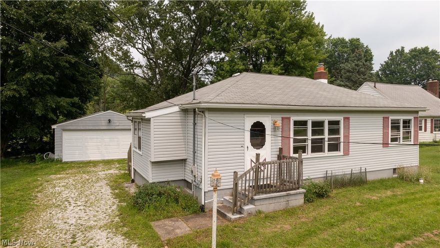 1967 E Turkeyfoot Lake Rd Akron is a great layout ranch home in the Green Local School District. 1st Floor Living for ease includes spacious Living Room, Eat-In Kitchen, Side Porch mud room entry from drive, 2 beds, 1 bath & large basement with laundry room & oversized detached 2-car garage with newer overhead garage door on almost acre lot on 2 parcels includes 107 ft frontage and is 353 feet deep. Newer carpeting throughout the living areas & the eat in kitchen has lots of cabinetry and there is a mud room leading to the large back yard. The partially finished basement, with Ohio State Waterproofing has a transferrable warranty, can be a rec room and office. The .8562 acre property has plenty of room to play and feel like you are in the country yet close enough location that is perfect for surrounding golf, lakes and shopping. The garage offers plenty of space for storage or workshop and the huge basement includes partially finished bonus room and the laundry area has enough space fo