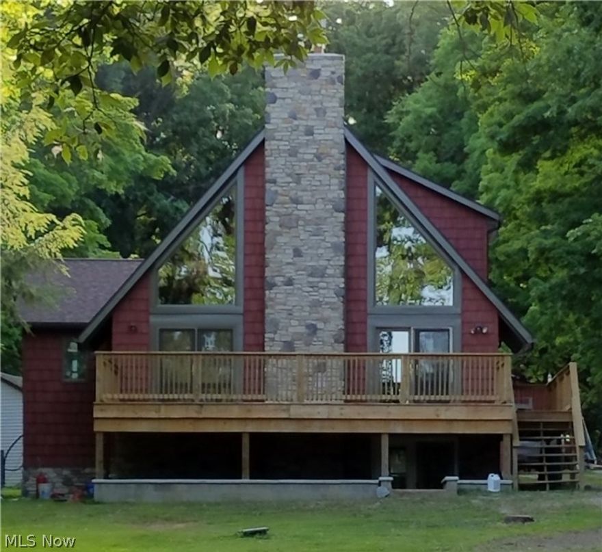 Beautiful A-frame home with a wall of windows!  Beautiful wood walls and ceilings, open air with soaring ceilings.  Kitchen has terrific stainless steel appliances, granite counters, hickory cabinets, 1st floor laundry.  Master could be on 1st floor or 2nd.  Loft has a spectacular bedroom and gorgeous bathroom with granite counters, whirlpool tub and shower.  First fl also has bathroom with granite.  Lower level walk out to stamped patio, deck off the great room.  Small landscape pond, shed and 30x40 outbuilding with concrete floor.