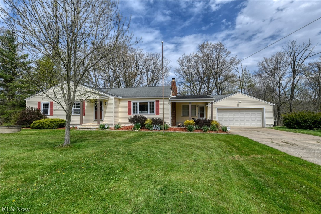 Fresh air and sunshine outside; excellent updates inside! This ranch home is set on over 3 acres with a backyard that steps down through a wooded ravine to a small bubbling creek. The interior features a sunny living room with new vinyl flooring, three spacious bedrooms with hardwood flooring, an updated bath with subway tile shower surround and more. Plenty of windows and a sliding door ensure that the kitchen and dining rooms are also open and airy and they both feature a custom ceramic tile floor. The finished lower level has a large recreation room as well as a workout room/office and an entertainment area. Your extended, tiered deck provides a relaxing outlook and plenty of space to entertain. With a wide 2-car garage and a manicured front landscape this home is perfect for sneaking away from a busy life and enjoying a bit of serenity. Call your favorite Realtor for a personal tour!