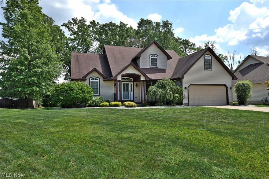 A gorgeous, large family home set in a quiet private drive. This beautiful residence has it all, with great looks inside and out, a large, neatly landscaped yard and a variety of updates. Tasteful rock and stone work line the outside of the home, wrapping the both the covered front and rear patios and expansive deck area. Inside, an open foyer presents staircase views as you look on past the formal dining and living room areas. Lush cream-colored carpet fills each room as natural wood trim work provides tidy accents. The spacious living room features a cornerstone fireplace, sharing great views and warmth with the adjacent kitchen area. Here, patterned tile work makes its way across the near wall and into the backsplash as a foray of cabinets wrap the room amongst white appliances. A natural colored tile floor continues into a nearby half bath and leads towards garage entry. A first-floor master bedroom is complete with a stunning private bath area with bespoke glass walled shower and