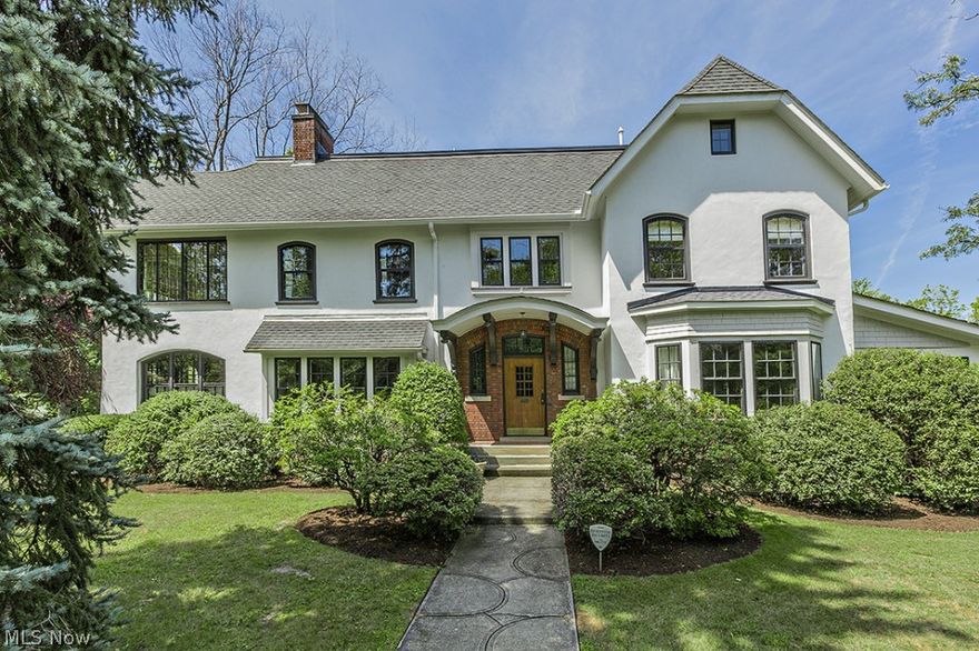 Stately Ambler Hts Stucco Center Hall Situated On A Private,  Extra Wide Lot.  Unusually Light & Bright Interior Showcases Gracious Room Proportions & Architectural Details: Arched Windows, Hardwood Floors & 4 Fireplaces.  Large Entry Foyer w/ Step Down To Rear Entry.  Living Room w/Fireplace & French Doors To Sun Room/Den.  Banquet-Sized Dining Room w/Fireplace.  Sunny Breakfast Room & Spacious Butler's Pantry Off Dining Room. Updated Kitchen w/New Granite Counters, Attached Mud Room & Full Size Laundry Room.  Bonus Maid's Breakfast Room & Back Staircase.  Master Suite w/Sun Room & Private Full Bath. Two Additional Bedrooms w/Jack & Jill Bath,  Additional Bedroom w/Private Bath & Cozy Sun Room Plus Original Linen Room Complete The 2nd Floor. Finished 3rd Floor w/ Bedroom & New Full Bath.  Zoned Heat & A/C. Finished Recreation Room. Basement Waterproofing. Many Improvements.  Fabulous Location Steps From Case, Univ Hosp, Little Italy, & Cedar-Fairmount Shops!