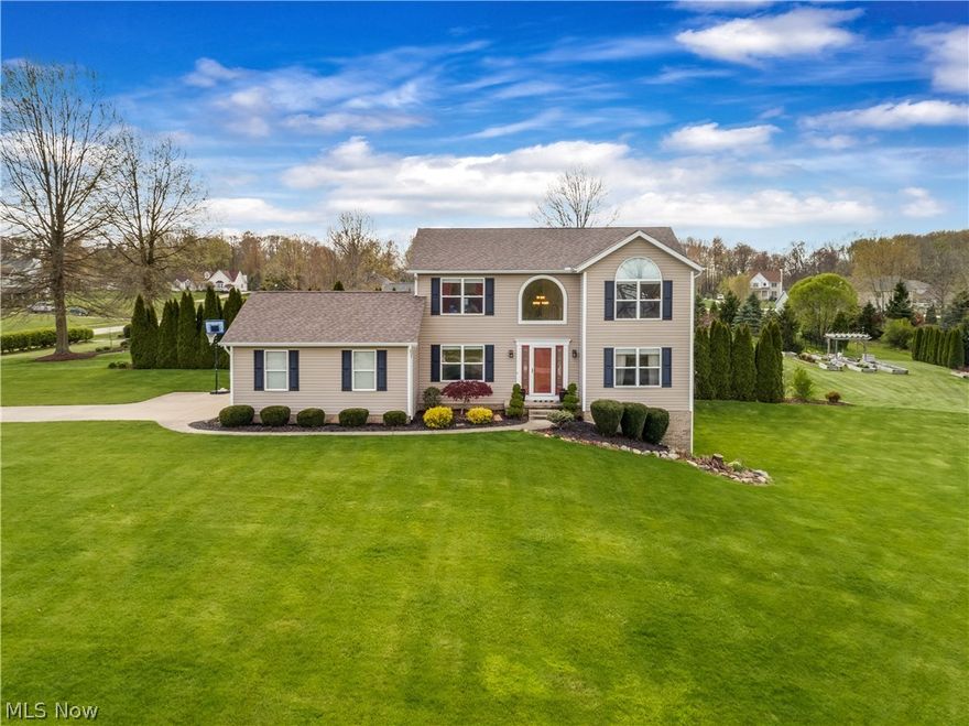 Welcome home to this incredible colonial located in Wadsworth Township's Golden Ridge Farms! Situated on a nearly 1 acre lot, the exterior is surrounded by lush landscape and plenty of outdoor yard and living space. The 2 story foyer is flooded with light from the arched window. Natural woodwork accents updated tile, carpet and laminate wood-look flooring throughout the home! The open concept kitchen features modern countertops & lighting, a breakfast bar and lots of cabinetry! The adjacent dinette has sliding glass doors to the tiered deck and patio! The spacious living room hosts an angled gas fireplace. A formal dining room, 1/2 bath and laundry room round out the 1st floor. The walkout lower level offers plenty of storage space in addition to a roomy rec area with walkout doors to the brick paver patio and glass French doors that separate a bonus room/office! The vaulted master bedroom suite has dual closets and a gorgeous en suite bath with tile flooring, updated fixtures and a je